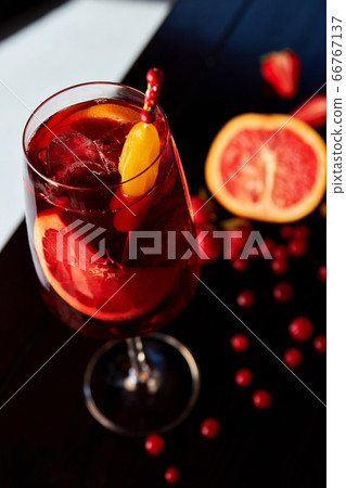 Glass of aperol spritz cocktail on wooden table in 66767137
