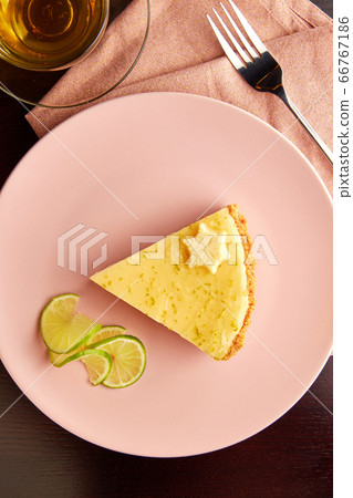 Piece of tart with lime zest and slice of limes. Piece of tart with lime zest and slice of limes. 66767186