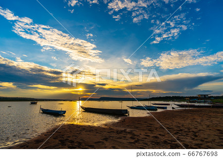 wooden boat at banks of the river with sunset in 66767698