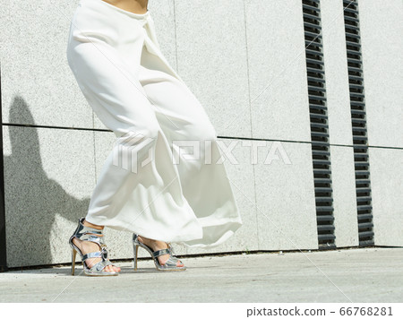 Woman wearing high heels and culottes Woman wearing high heels and culottes 66768281