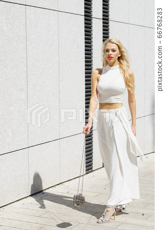 Woman wearing crop top and culottes Woman wearing crop top and culottes 66768283