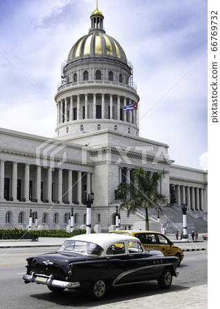 Cuba Havana Classic car running in front of the Old Parliament Building Cuba Havana Classic car running in front of the Old Parliament Building 66769732