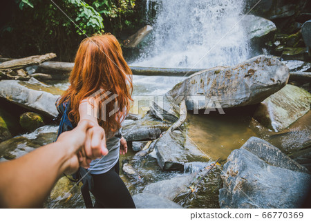 Male and woman couples asia. Walking hand travelers travel nature Forests, mountains, waterfalls 66770369