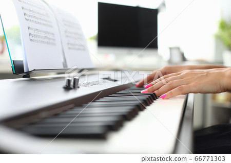 Young woman hands playing piano at home Young woman hands playing piano at home 66771303
