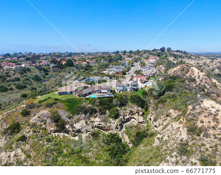 Aerial view of upper middle class neighborhood with residential house and swimming pool in a valley Aerial view of upper middle class neighborhood with residential house and swimming pool in a valley 66771775