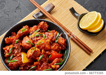 Fish Manchurian dry or Schezwan Fish in black bowl at dark slate background. 66773385