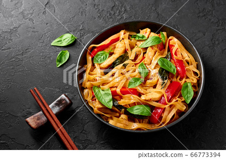 Thai Drunken Noodles or Pad Kee Mao in white plate at black slate background. Thai cuisine dish 66773394