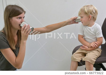 Boy with Cochlear Implants Playing Tin Can Phone 66773822