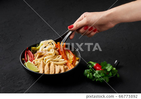 Chicken Thukpa in black bowl at dark slate background. Chicken Thukpa is Tibetan cuisine noodle soup Chicken Thukpa in black bowl at dark slate background. Chicken Thukpa is Tibetan cuisine noodle soup 66773892