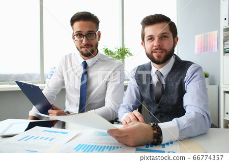 Joyful business colleagues working together in office Joyful business colleagues working together in office 66774357