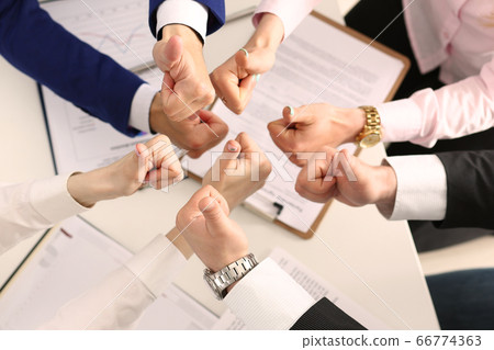 Group of business people giving thumbs up Group of business people giving thumbs up 66774363
