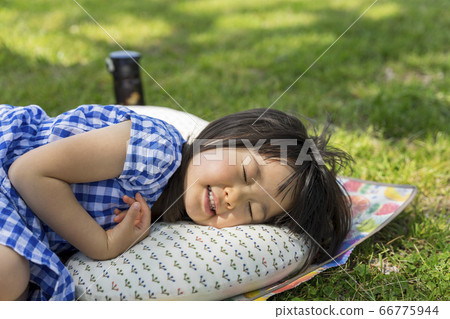 Girl taking a nap outside 66775944