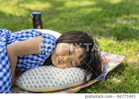 Girl taking a nap outside 66775945