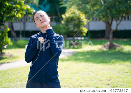 Portrait of Asian woman wearing earphones 66778237