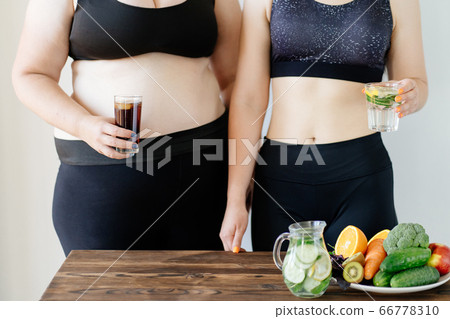 Fit woman with water and obese woman with soda Fit woman with water and obese woman with soda 66778310