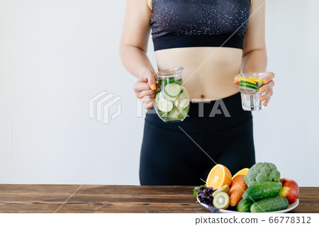 Detox, hydration. Fit woman drinking infused water Detox, hydration. Fit woman drinking infused water 66778312