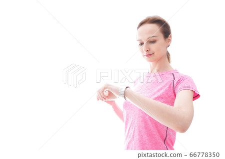 Young woman wearing sportswear checking smartwatch 66778350