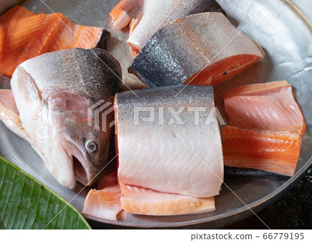 Sliced fresh salmon fish head for sale in the seafood market. Sliced fresh salmon fish head for sale in the seafood market. 66779195