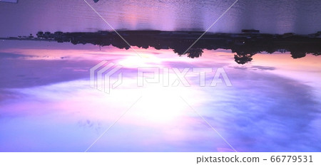 Sunset above an island at Nusa Dua in Bali, Indonesia 66779531