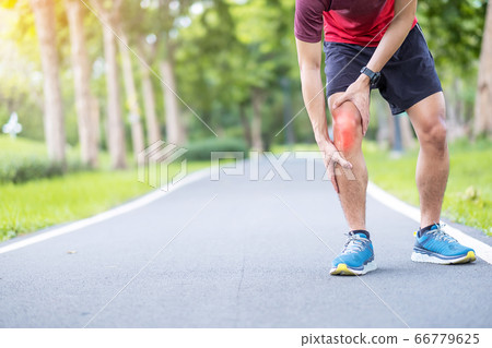 Young adult male with muscle pain during running. 66779625