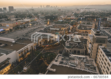 The Grove Shopping Center in Los Angeles at Sunset with Shops and Hollywood Skyline in the distance The Grove Shopping Center in Los Angeles at Sunset with Shops and Hollywood Skyline in the distance 66780564