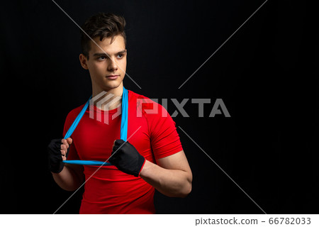 Young athlete with red t-shirt stands for picture Young athlete with red t-shirt stands for picture 66782033