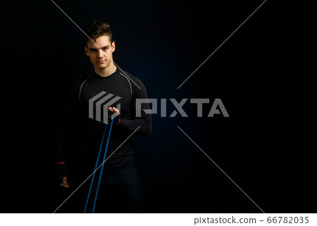 Young athlete with black t-shirt stands for picture Young athlete with black t-shirt stands for picture 66782035