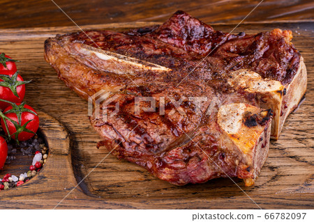 Fried Ribai steak, with spices, languished on coals, served with tomatoes Fried Ribai steak, with spices, languished on coals, served with tomatoes 66782097