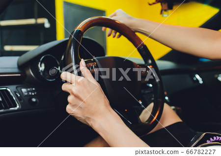 Close-up Of Woman's Hand Holding Steering Wheel. 66782227