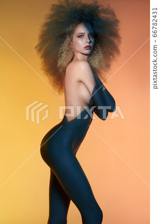 Nude sexy blonde in colorful light. Night club Nude sexy blonde in colorful light. Night club 66782431