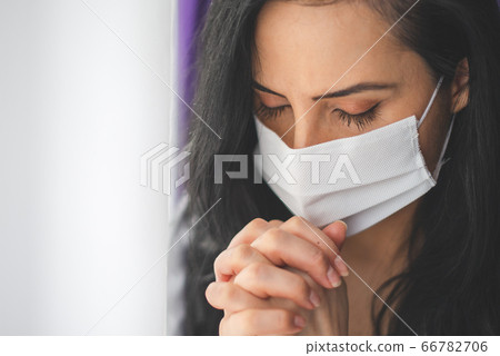 Portrait of woman with surgical mask praying 66782706