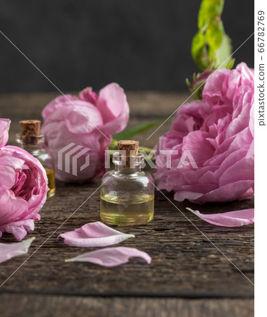 A bottle of rose essential oil with rose de mai 66782769