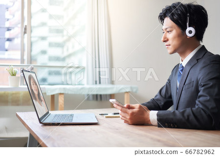 Man wearing a headset and making a video call 66782962