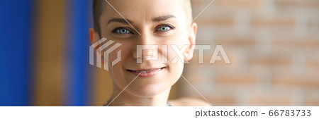 Pretty girl with creative haircut smiles close-up Pretty girl with creative haircut smiles close-up 66783733
