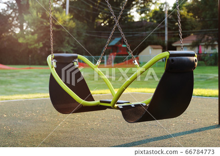 Empty children playground swing during the coronavirus quarantine Empty children playground swing during the coronavirus quarantine 66784773