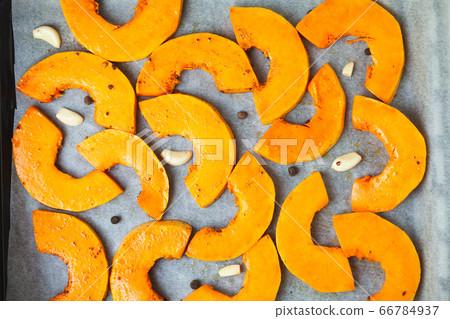 Bright slices of pumpkin prepared for baking in the oven 66784937