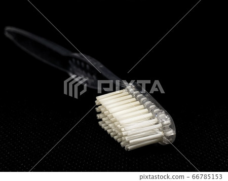 White toothbrush on the black background  66785153