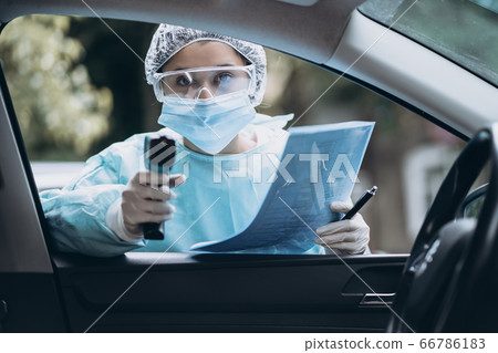 Doctor woman use infrared thermometer gun to check body temperature Doctor woman use infrared thermometer gun to check body temperature 66786183