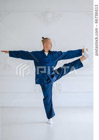 Handsome man doing yoga pose isolated on a white background 66786813