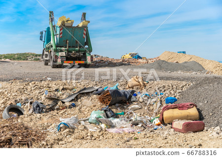 the garbage truck brought the waste to the landfill 66788316