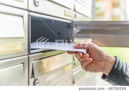 letter in the mailbox of an apartment building letter in the mailbox of an apartment building 66788589