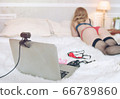 Sexy girl in stockings in front of a laptop webcam shows a Striptease in a video chat 66789860
