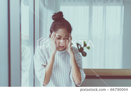 Asian woman having a headache in bedroom,Women suffering from migraine at home 66790004