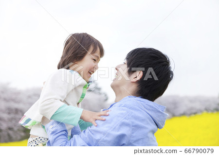 A father lifting a child 66790079