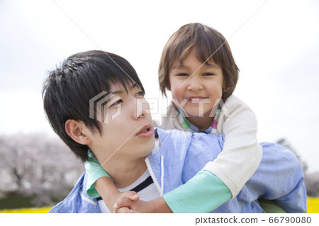 Father carrying a child Father carrying a child 66790080