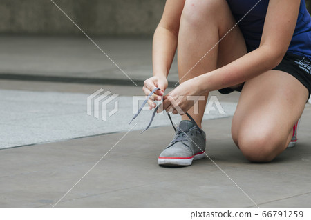 Sport sneakers footwear young woman knelt down do Sport sneakers footwear young woman knelt down do 66791259