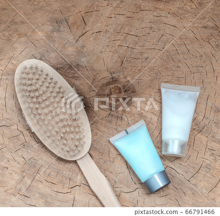 Spa accessories - scrub, facial brush, clay face mask, on a light wooden background Spa accessories - scrub, facial brush, clay face mask, on a light wooden background 66791466