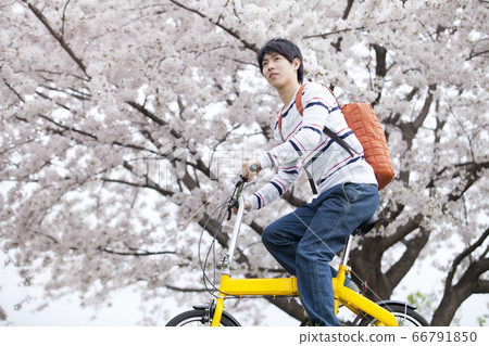 A man riding a bicycle 66791850