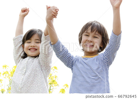 Boys and girls holding hands and doing banzai Boys and girls holding hands and doing banzai 66792645
