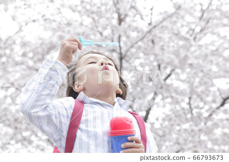 Boys playing with soap bubbles 66793673